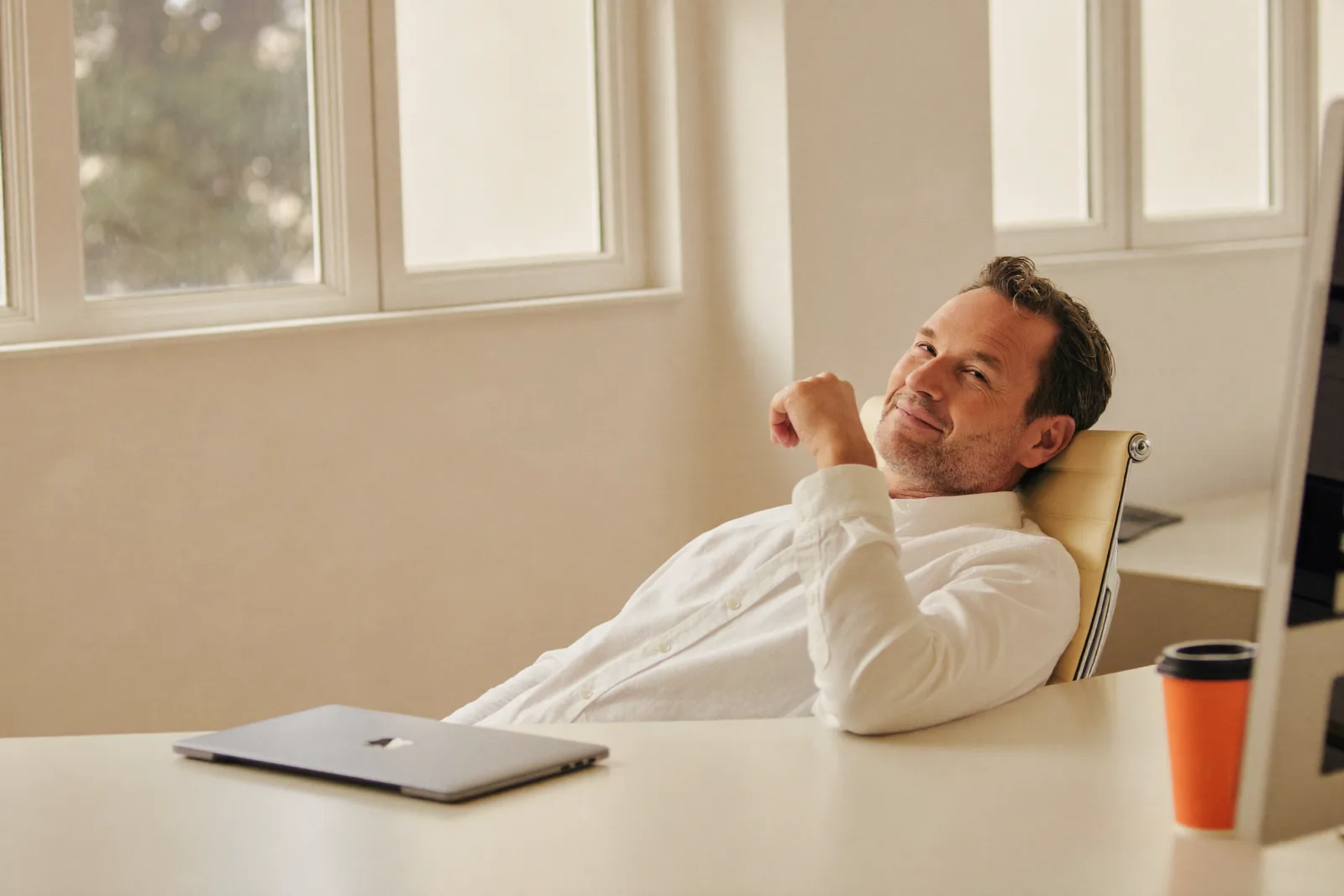 Relaxed executive at a tidy desk