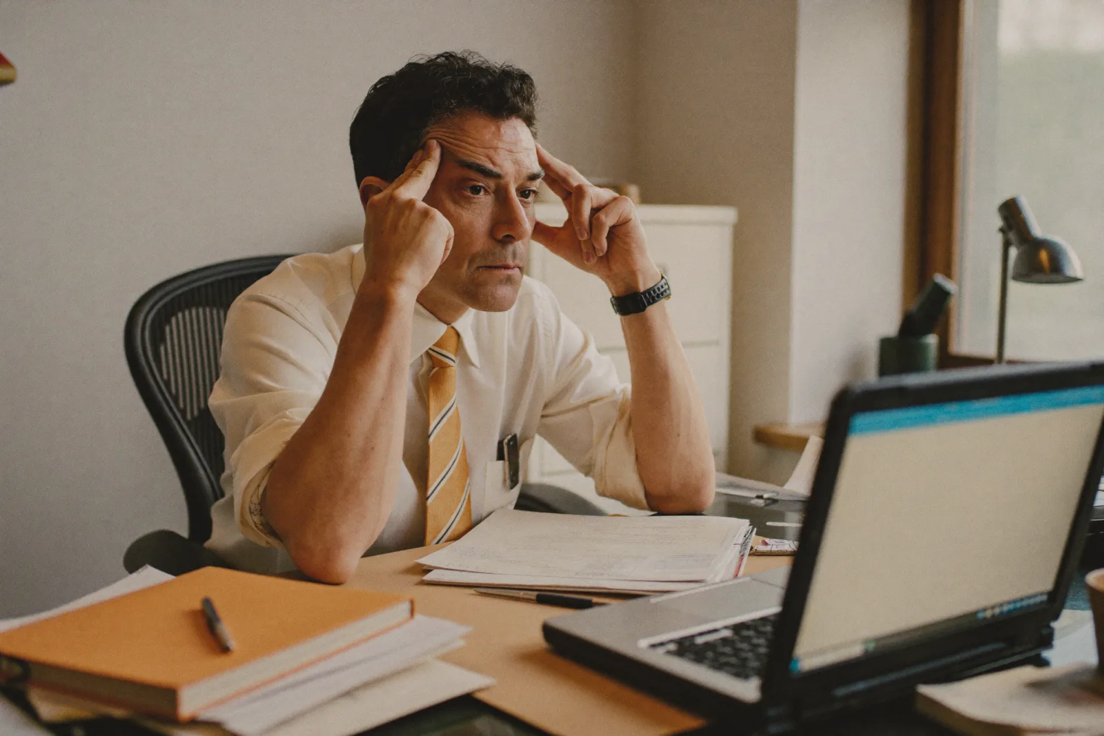 Stressed executive at a cluttered desk